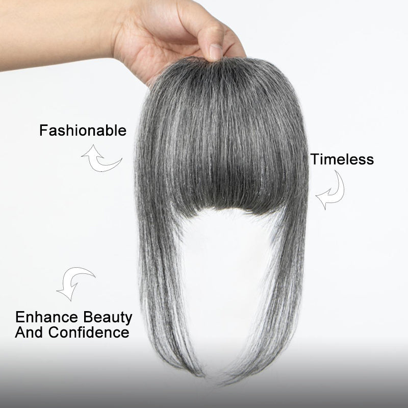 Soul Lady Wigs medium salt and pepper clip-in full bangs hairpiece with long face-framing sides, held by hand against a clean white background to show texture and color detail.