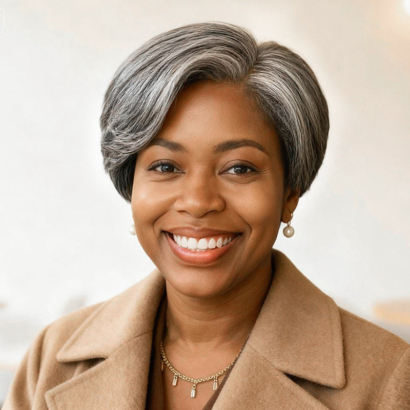 A beautiful middle-aged African American woman wearing the Soul Lady Salt and Pepper Straight Layered Pixie Wig. The short, sleek layers blend gray and black tones for a natural salt and pepper style. 