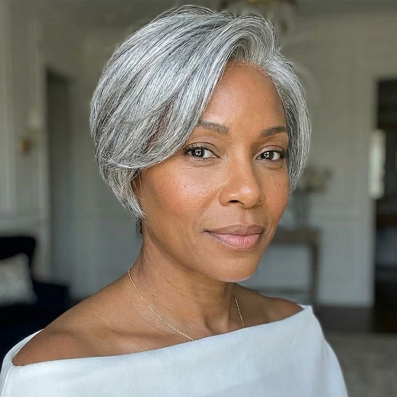 A beautiful middle-aged African American woman wearing the Soul Lady Salt and Pepper short Straight Layered Pixie Wig 4 inch. The short, sleek layers blend gray and black tones for a natural salt and pepper style. 